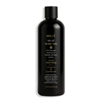 Black bottle of Millé No. 01 Amber Halo pet shampoo and conditioner on a white background
