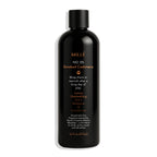 Black bottle of Mille No. 05 Smoked Cashmere Shampoo & Conditioner on a white background